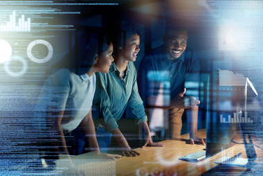 Business professionals collaborating on AI strategy using data dashboards to build a strong foundation for successful artificial intelligence implementation