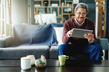 Person using a tablet to review trusts and estate planning options for long-term financial security.